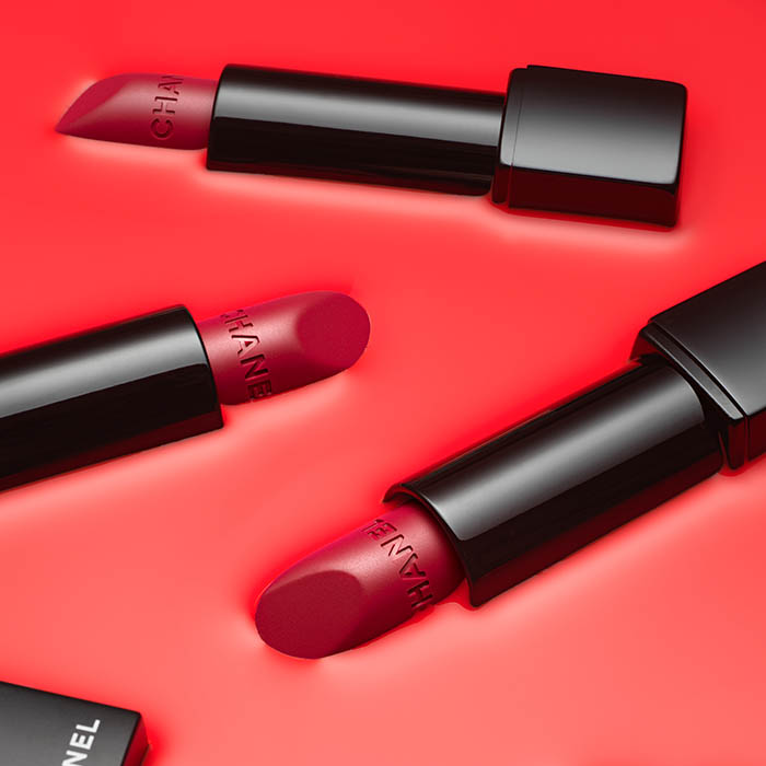 Image of Chanel lipsticks submerged in red paint