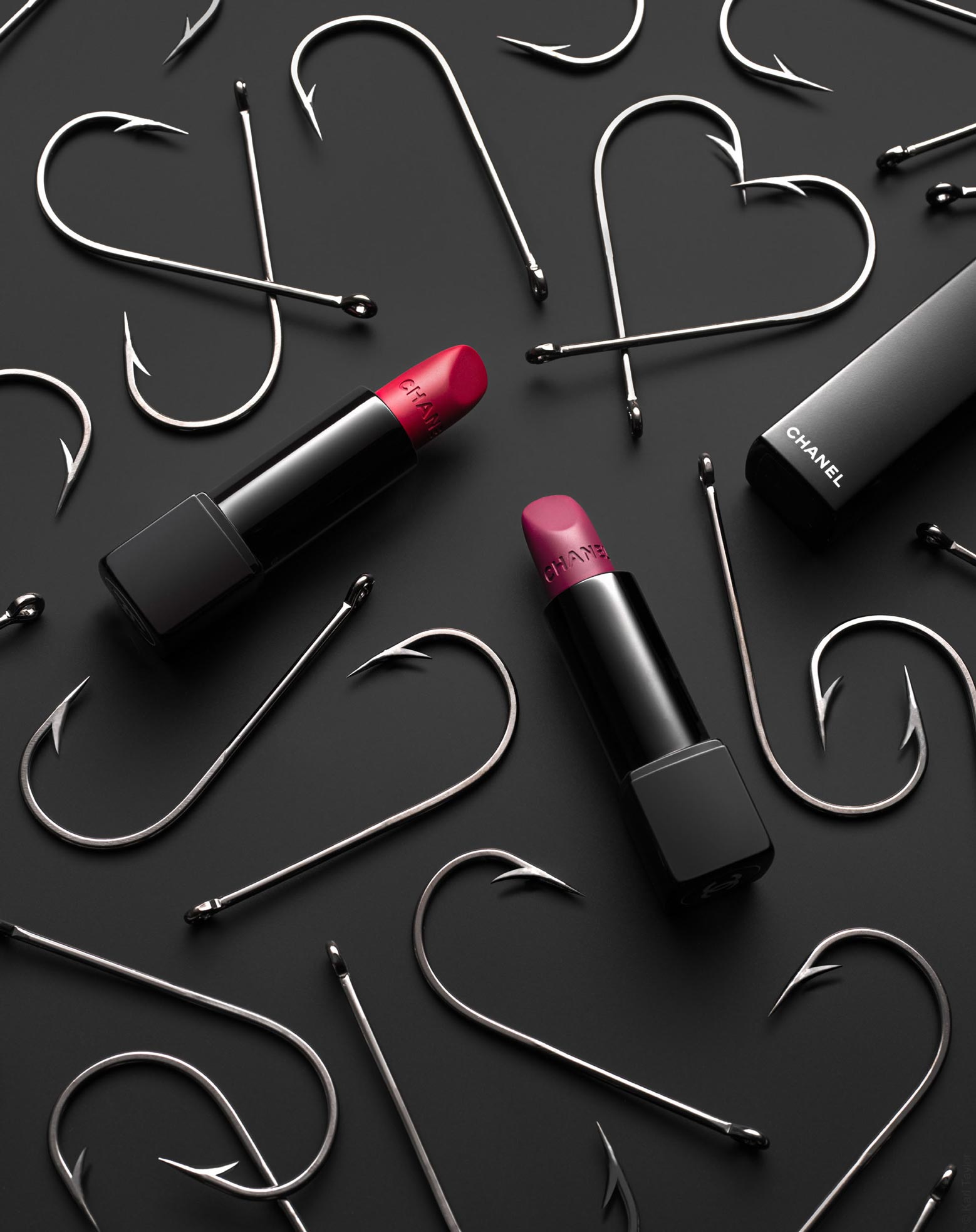 Lipstick still life photo with fishing hooks and a black backdrop